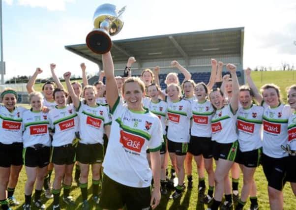 Sinead McCleary, Queen's University, Belfast, captain lifts the cup as her team-mates celebrate. Picture credit: Matt Browne.