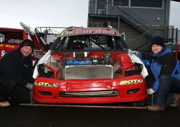 Paul Gordon and Ryan Logan working on their car during the pratice evening at Ballymena Raceway. INBT13-261AC