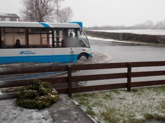 A bus negotiates 'the lake' at Meeting House Lane.