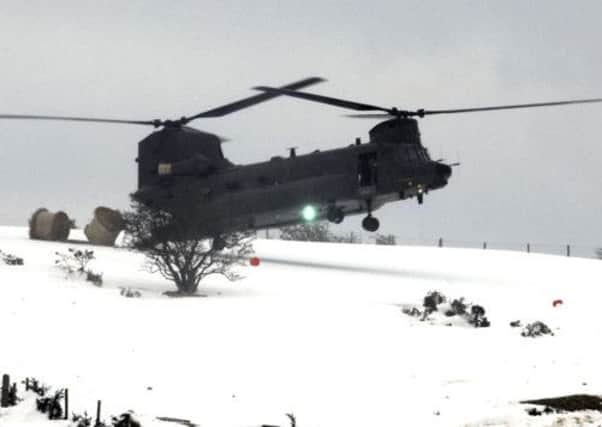 Lifeline......A Royal Air Force Chinnook helicopter, delivers much needed round bales, to livestock on the Dree HFAill Road, Finnis, during the recent snow crisis, to hit South Down.  © Photo: Gary Gardiner.