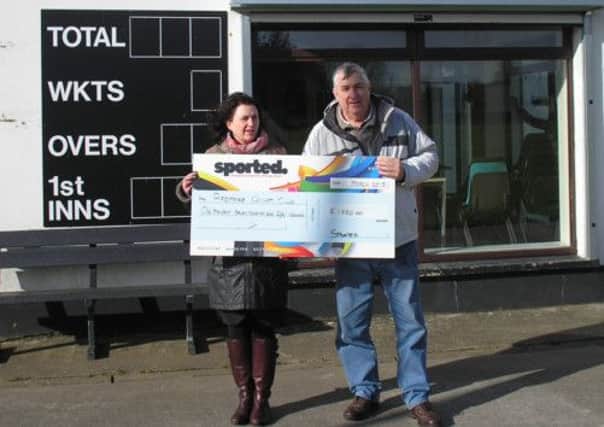 Brenda Kelly the Sported, Northern Ireland Manager pictured presenting a cheque to Ardmore Cricket Club chairman Dermot Ward.