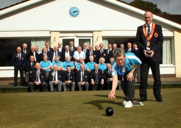 Barbara Burnett (Lady President) delivers the first bowl of the season to official open Ballymena Bowling Club as looking on is Nigel Robinson (President) and club members. INBT14-250AC
