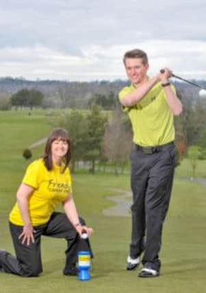 Josh Hall swings into action to launch his first charity golf day, which will take place at  Edenmore Golf Club on Friday, May 10, cheered on by Claire McAuley, Friends of the Cancer Centre.