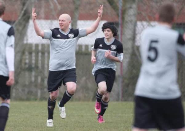 Celebration time in the 'derby' game between Ballymacash's firsts and seconds. Pic: Cliff Donaldson