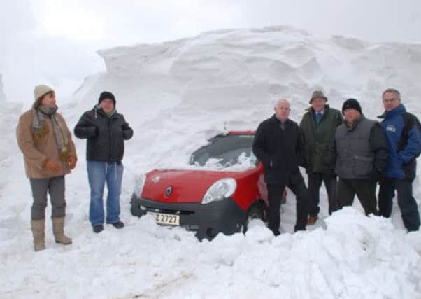 Councillors Maureen Morrow, James McKeown, Drew Niblock, Martin Wilson, Alderman Roy Beggs and Environment Minister Alex Attwood at a house in Feystown badly affected by the snows. INLT 14-329-PR