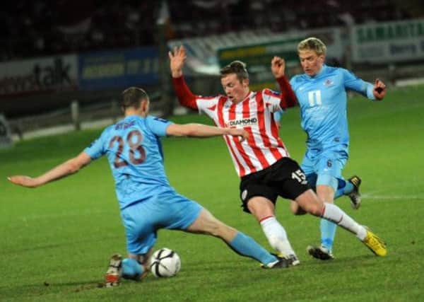 Derry City's Michael Rafter skips away from Drogheda United defender Michael Byrne.