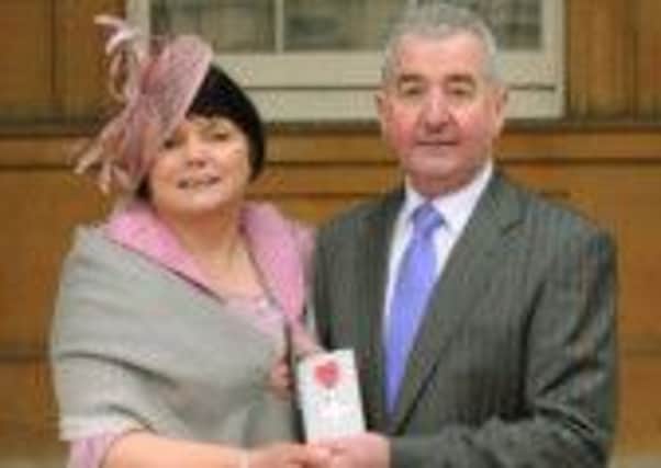Trevor Hassin with wife Daphne in the grounds of Buckingham Place after he received the MBE. INLT 15-601-CON