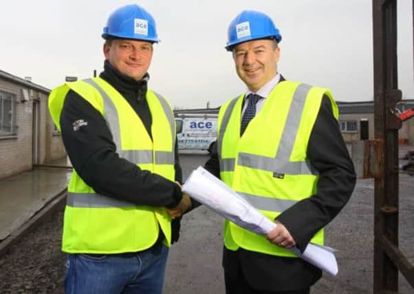 Mark Johnston, right, from Ulster Bank marks the investment with the companys Managing Director Martin Mullan