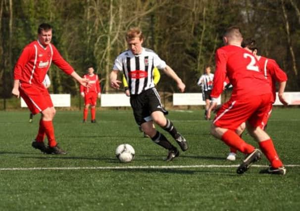 Wakehurst's Ryan Gregg weaves his way through the Chimney Corner defence during Saturday's Championship Two victory at Mill Meadow. Picture: Damian McKee.