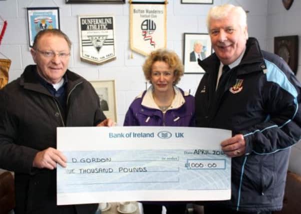 Davy Gordon receives his £1,000 Sports Bond jackpot cheque from United chairman Robert Cupples. Also included is Jo Gillen, who runs the Hawthorn Bar agency. Picture: Reid McAuley.