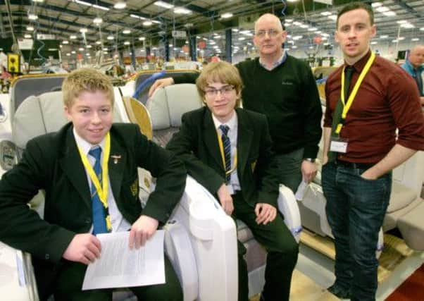 Connor McWhirter and Matthew Ennis, students at Belfast High School with Stephen Collins from B/E Aerospace and DJ Connor Phillips during their visit to the Kilkeel factory. INNT 15-604con