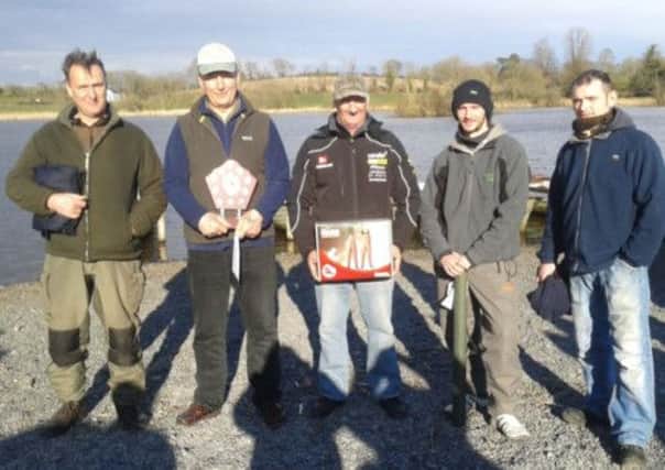 Bill Johnston (centre) from Lurgan shows off his prize thanks to success at Islandderry Trout Fishery.INLM15-160
