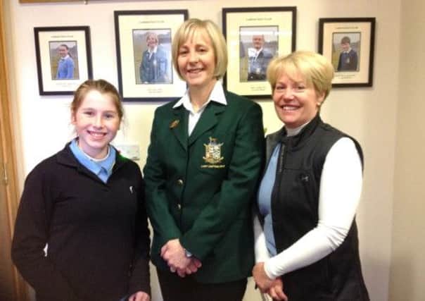 Anne Knox (centre, lady captain) offers her congratulations to, from left to right, Maeve Cummins and Katrina Bradford following the players' second place in the 18-hole Adult/Girls competition.INLM15-162