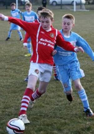 Action from Monday night's NIBFA Cup under-11 semi-final between Carniny Youth and Ballymena United Youth Academy at Clough.