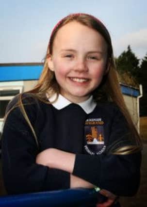Braidside Integrated PS pupil Emma Martin who won an Aer Lingus, Ulster Rugby design a rugby shirt competition, and Emma, along with her class, will get a day trip to London. INBT15-214AC