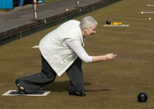 Lorna Ross, wife of Jim Ross, club President, throwing the first bowl to officially open the new season for City of Derry Bowling Club at the Lisnagelvin Bowling Greens on Saturday. INLS1513-107KM