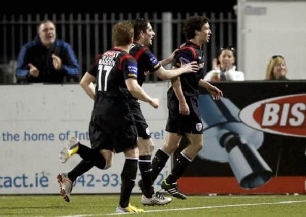 Derry City's Barry McNamee celebrates with team-mates Ruaidhri Higgins and Simon Madden, following his super goal at Dundalk.