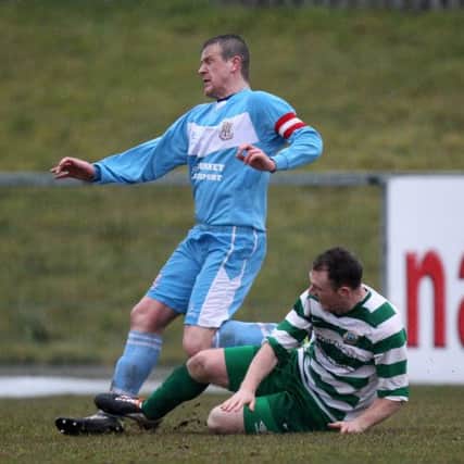 Donegal Celtic's Ciaran Burns tackles Ballymena captain Alan Jenkins, a challenge which led to Jenkins being stretchered off with ankle ligament damage. Picture: Press Eye.