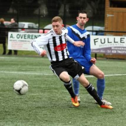 Wakehurst's Lee McCaughern turns away from a Ballymoney United opponent during Saturday's 1-1 draw at Mill Meadow. Picture: Damian McKee.