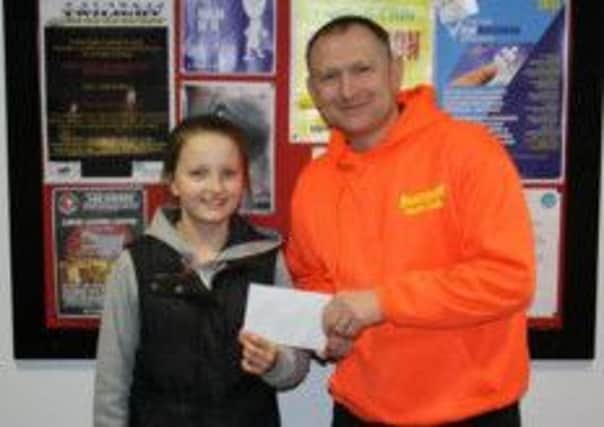 John Clarke from Seacourt Youth Club presents Lauren Ferguson with a gift voucher for being the 50th person to like Seacourt Youth Club's new Facebook page. INLT 16-606-CON