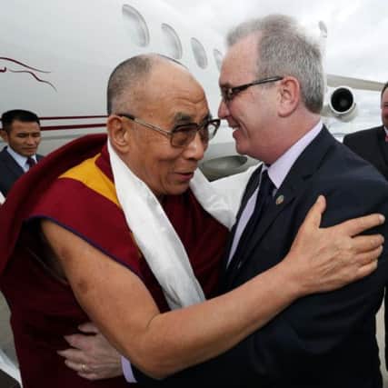 Handout photo of His Holiness, the 14th Dalai Lama of Tibet being welcomed by Richard Moore, Director of Children in Crossfire, at City of Derry Airport as he touched down for a one day visit to the UK City of Culture Derry/Londonderry. PRESS ASSOCIATION Photo. Picture date: Wednesday April 17, 2013. See PA story ULSTER Tibet. Photo credit should read: Lorcan Doherty/PA Wire NOTE TO EDITORS: This handout photo may only be used in for editorial reporting purposes for the contemporaneous illustration of events, things or the people in the image or facts mentioned in the caption. Reuse of the picture may require further permission from the copyright holder.