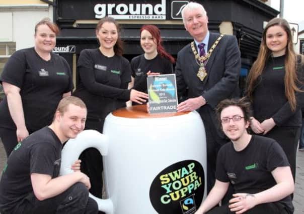 Councillor Sam Cole, Mayor of Coleraine, pictured presenting the Coleraine Borough Fairtrade Cafe Awards 2013 winner award to staff of Ground Espresso Bar in Coleraine. Included are staff, Danny Clarke, Chris Mooney, Louise Elliott,  Louise Ellis, Jenny Rowntree and Leona O'Reilly. CR17-404PL