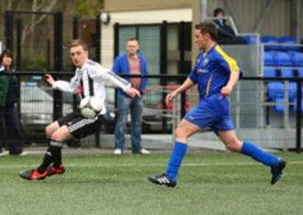 Wakehurst striker Conor Gregg turns away from a Moyola Park opponent during Saturday's Championship Two match at Mill Meadow. Picture: Damian McKee.
