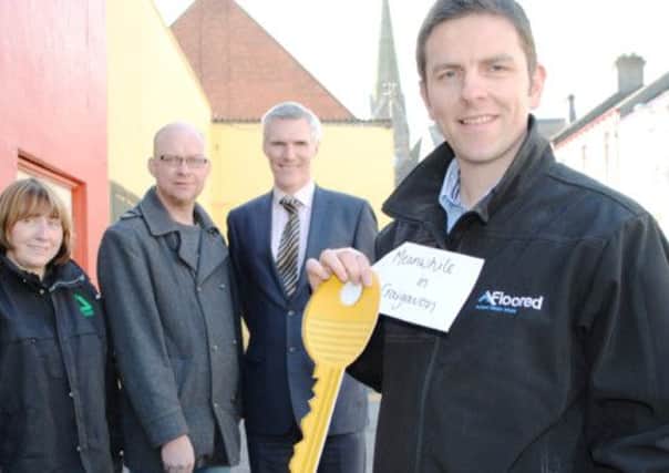 Lurgan businessman Mark Savage (right) takes the ceremonial key to his new premises on Queen Street as part of the Meanwhile in Craigavon... initiative, while Madeleine Kelly (left) from Groundwork NI, Cllr Paul Duffy and Derek Browne from Insight Business Consulting (second right).