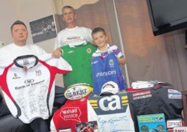 Lewis Bronze (right) with father, Neil (left) and family friend (Derek Leonard) with lots of sports and showbiz memorabilia auctioned in aid of a kids' heart care charity a few years ago.