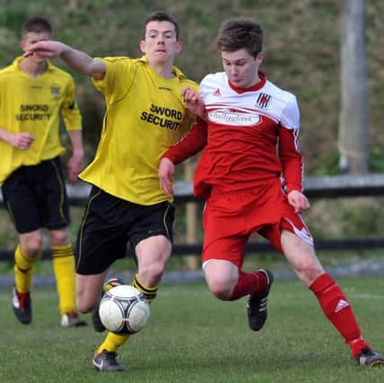 Wakehurst's Ryan Young challenges Knockbreda's Michael McClean during Saturday's Championship Two game. Picture: Press Eye.