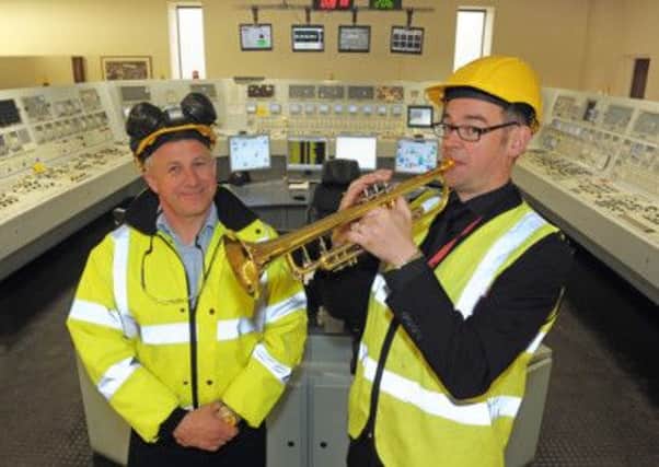 AES and the Ulster Orchestra have formed a new partnership. AES will be sponsoring the Ulster Orchestra's principal trumpet player Patrick McCarthy. He is pictured wth Davy Elliott, from AES. INLT 18-657-CON aes. Pic by Simon Graham/Harrison's.