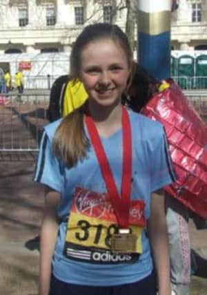Rachel Brown pictured with her medal after completing the recent London Mini Marathon.