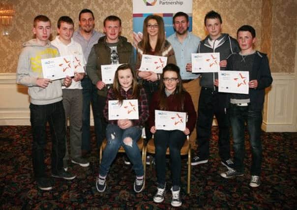 Young people from Larne with their Detached Youth Project certificates. They are joined by project workers John Wallace and Ross McKenzie. INLT 18-658-CON detach