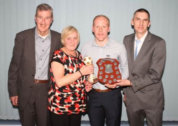 Dwayne Nelson receives the Seven Towers SC Player of the Year award from Joan Wright, of sponsors the Wright family, and the Noel Brown Memorial Shield from David Brown. Also included is Seven Towers SC chairman Tommy Patterson. Picture: Reid McAuley.