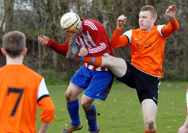 An Atletico Antrim player goes in bravely where it hurts in Saturday's match at Galgorm Blues. INBT 18-950H