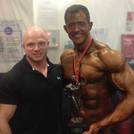 Robert Allen pictured with his NABBA Novice Mr Northern Ireland trophy and his training partner Paul Stewart.