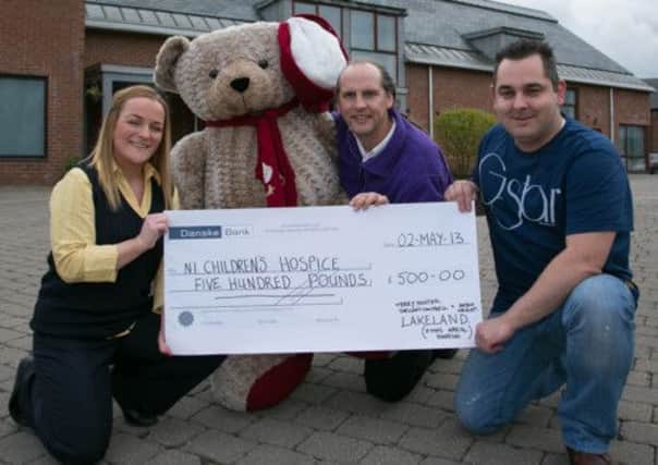 Lakeland employee Jacqui Wright and Stewart Campbell from Rathcoole present a cheque for £500 to NI Childrens Hospice fundraiser Peter McCabe at Horizon House. INNT 19-404-RM