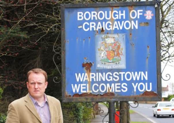 Councillor Colin McCusker pictured at one of the welcome signs in Waringstown.