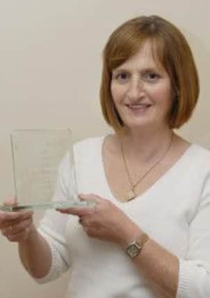 Lesley Buchanan with her award for 40 years service.