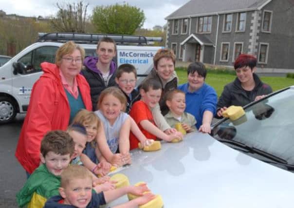 Volunteers washing cars at Larne and Kilwaughter Old Presbyterian Church to help raise funds for a defibrillator to be kept in the church. INLT 19-380-PR