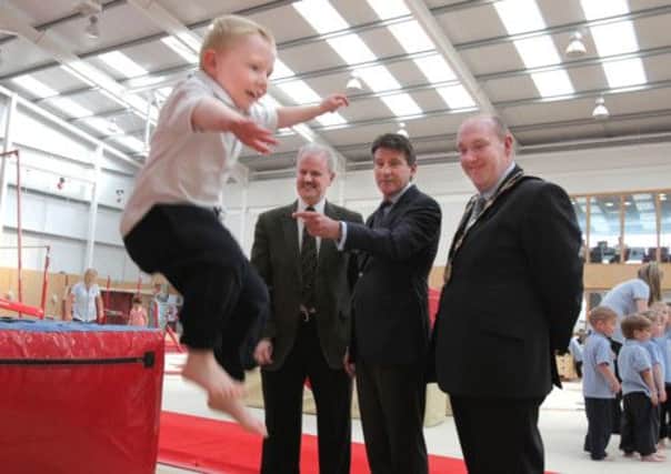 Pictured during Lord Coe's visit to Salto Gymnastics Centre is Wallace pre-preparatory pupil, Evan Dorritt, demonstrating his vaulting skills to Lord Coe, with Cllr Thomas Beckett, Lisburn City Council and Mayor, Alderman William Leathem. Picture by Brian Thompson/ Press Eye