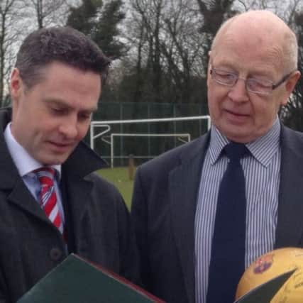 Cllr Paul Frew, pictured here with fellow DUP Cllr Hubert Nicholl, is calling 'foul' on pet owners who fail to clean up after their dogs on streets and public play areas in the borough such as football pitches.