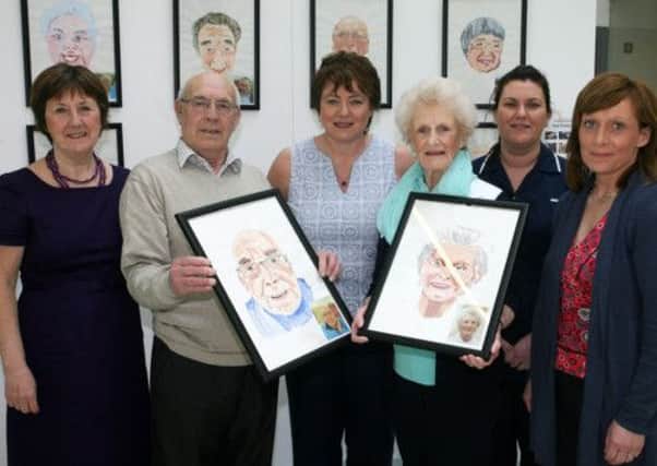 Tom Foster and Anna McErlain, of Wilson House (Brougshane), show off their self portraits along with Audrey Loughhart (Chairperson Reminiscence Network), Geraldine Gallagher (Reminiscence Network), Amanda Halliday (Daycare worker) and Colette Fairley (Manager Wilson House) during their exhibition at The Braid. INBT19-209AC