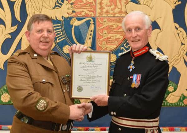 Sergeant Major Instructor William Barr pictured receiving his Certificate of Outstanding Meritorious Service Above and Beyond The Call of Duty from Colonel Denis Desmond CBE, Her Majestys Lord Lieutenant for the County of Londonderry.  INLT 20-676-CON