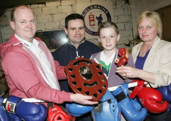Christopher and Teresa Conor present the Chrissy Conor Memorial Shield to Coleraine Boxing Club's Ben Henderson who won Club Man of the Year with Rory Duddy, coach. INCR20-412PL