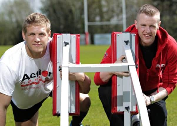 Rugby star Chris Henry and Action Cancer Health Promotion Officer, Malachy Nixon, are set to tackle menâ¬"s health in Northern Ireland over the charityâ¬"s Action Man Campaign in June.  As part of campaign, which aims to raise awareness of menâ¬"s general health and of male specific cancers such as testicular and prostate cancer, Action Cancer is offering 700 free M.O.T. health checks for men across Northern Ireland. 

To find out more or to book an M.O.T. health check appointment visit www.actioncancer.org or call 028 9080 3344.