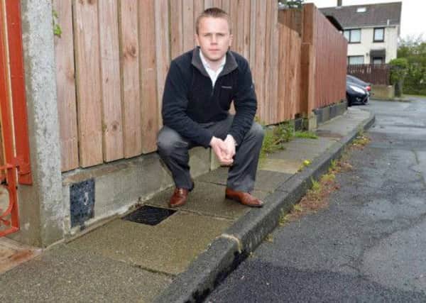 Newtownabbey Councillor,Thomas Hogg pictured with broken paving slabs at Tulleevin Walk, Rathfern. INNT 20-026-PSB