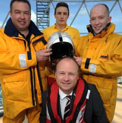 Barry Kirkpatrick, crew member at Larne RNLI (back, right), with Robert Latus, assistant mechanic at Newcastle RNLI, Rogan Wheeldon, senior RNLI lifeguard on the Causeway coast, and Hugh Black (front), Victoria Square centre manager. Picture: Paul Fee,