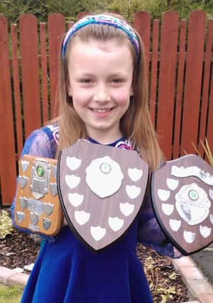 Aimee Leitch, from Maghermorne and a member of the Bentra School of Irish Dancing, is pictured with trophies she won in three dance classes at the Glenravel Irish dancing festival. INLT 21-628-CON