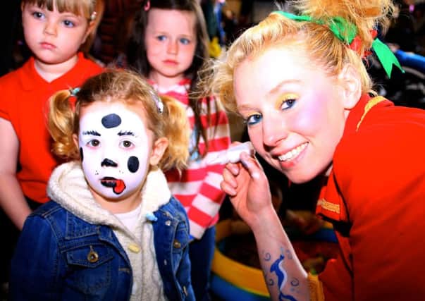 Children's entertainer Nicola Cunningham of FizzWizzPop! paints Nicola McCarey's face at the family fun day in Carnmoney Presbyterian Church hall. INNT 20-707-SK